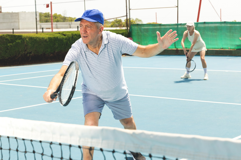 Tennis Players playing during the day.